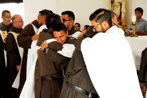 The newly professed exchange a sign of Peace with the Carmelites present.