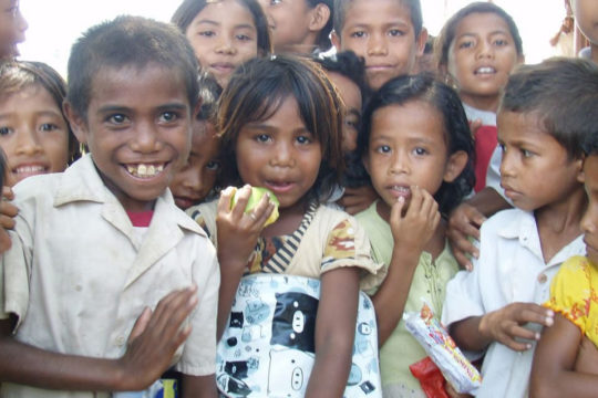 village children holding food and water