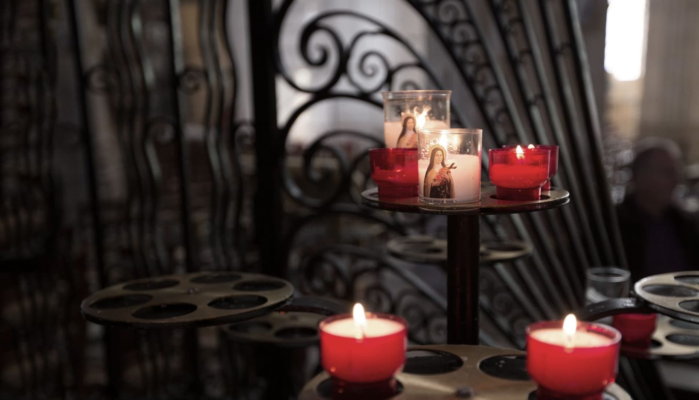 candle in front of iron grillwork