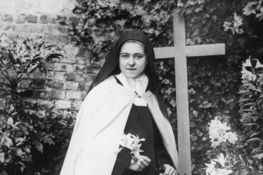 St. Therese, kneeling and holding Easter lily