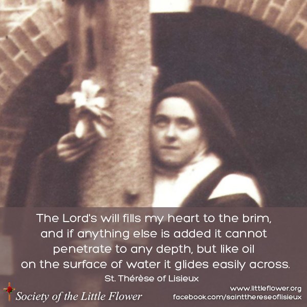 Photo of St. Therese of Lisieux, embracing the large crucifix in the courtyard at Le Carmel monastery.